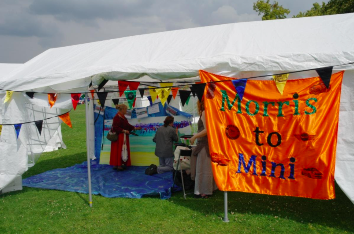Project tent with a sign outside reading, 'Morris to Mini'.